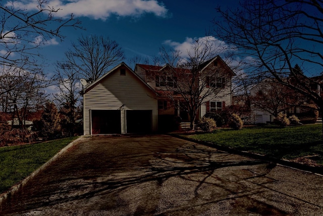 traditional-style house featuring a front yard and driveway