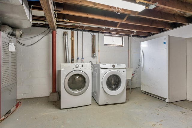 clothes washing area featuring laundry area and washer and clothes dryer