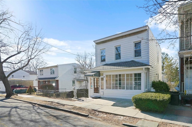 view of front of home featuring a patio area and fence