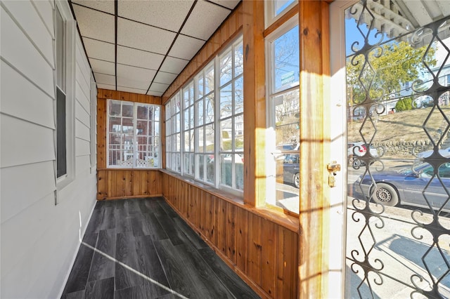 unfurnished sunroom featuring a drop ceiling