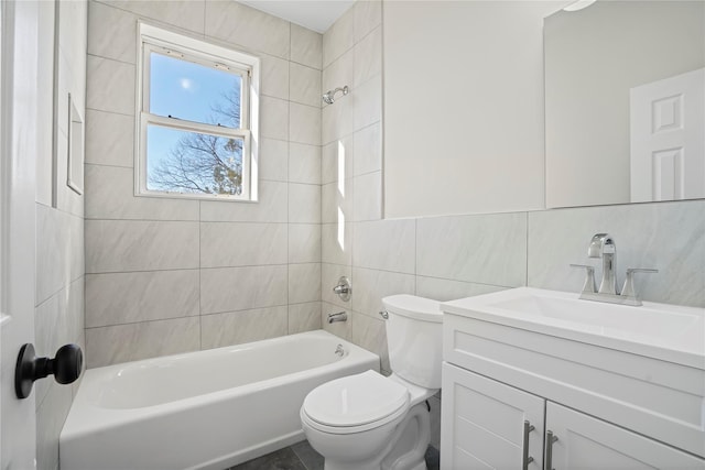 full bath featuring tasteful backsplash, tile walls, toilet, bathing tub / shower combination, and vanity