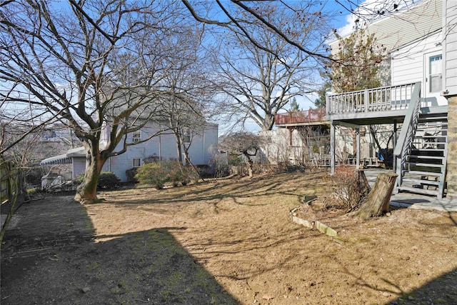 view of yard with stairs and a wooden deck