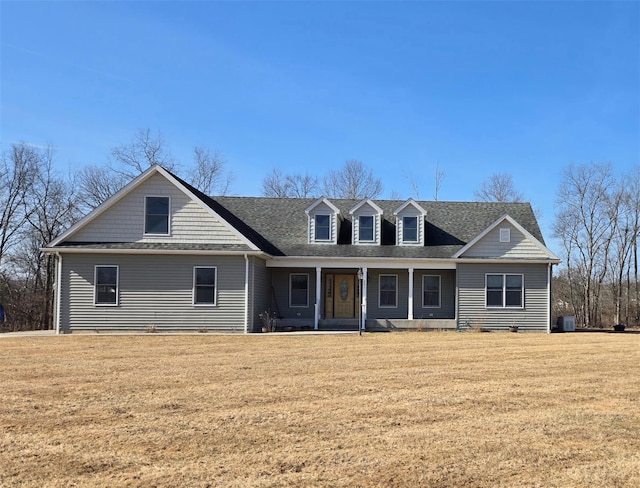 view of front of home featuring roof with shingles and a front lawn