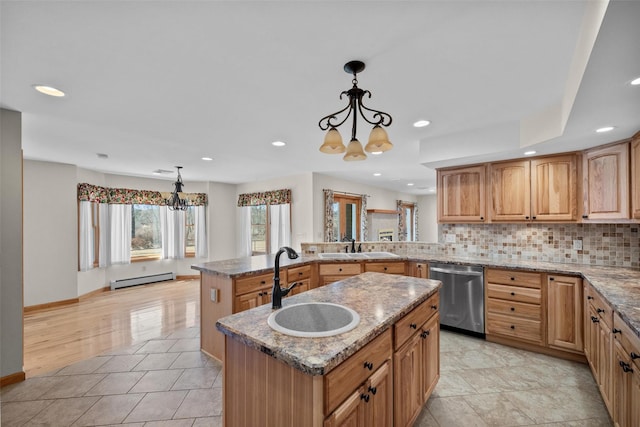 kitchen with light stone counters, decorative backsplash, baseboard heating, dishwasher, and a chandelier