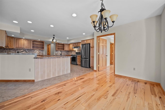 kitchen with under cabinet range hood, light wood-type flooring, decorative backsplash, stainless steel appliances, and open shelves