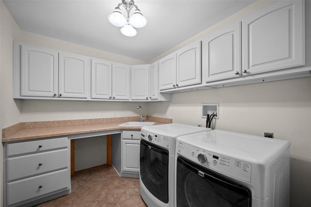 clothes washing area featuring a sink, cabinet space, a chandelier, and washer and clothes dryer