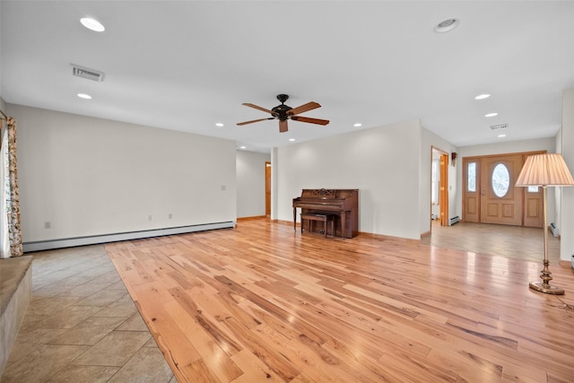 unfurnished living room with visible vents, light wood finished floors, recessed lighting, ceiling fan, and baseboard heating