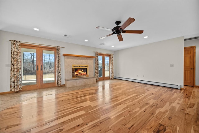 unfurnished living room featuring light wood-style floors, french doors, visible vents, and a baseboard radiator