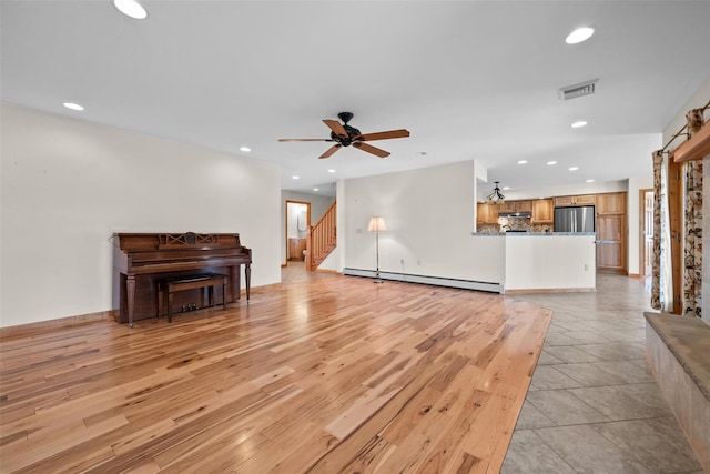 unfurnished living room featuring light wood-type flooring, visible vents, a ceiling fan, a baseboard heating unit, and recessed lighting