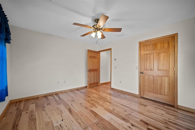 unfurnished bedroom featuring visible vents, baseboards, a ceiling fan, and light wood finished floors