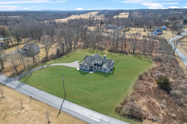 birds eye view of property with a rural view and a wooded view