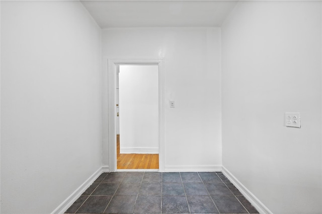 unfurnished room featuring baseboards