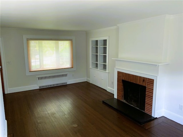 unfurnished living room featuring a brick fireplace, radiator heating unit, wood finished floors, and baseboards