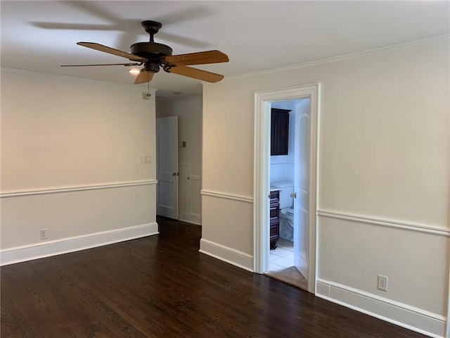 spare room with ceiling fan, wood finished floors, baseboards, and ornamental molding