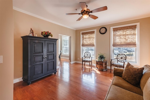 interior space featuring wood finished floors, a ceiling fan, and ornamental molding