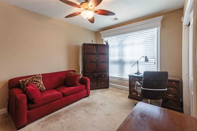 home office featuring a ceiling fan, visible vents, carpet floors, and baseboards