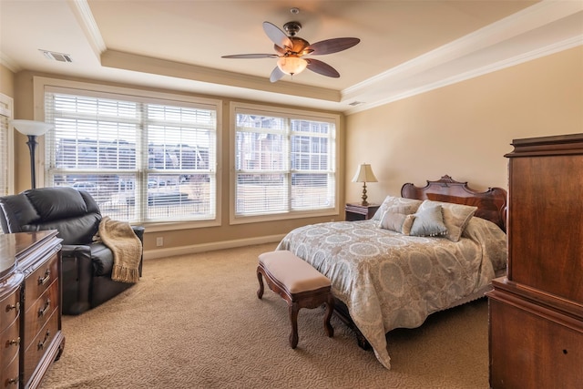 bedroom featuring visible vents, multiple windows, a tray ceiling, and ornamental molding