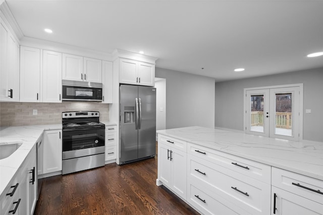 kitchen featuring appliances with stainless steel finishes, white cabinetry, dark wood-type flooring, and french doors