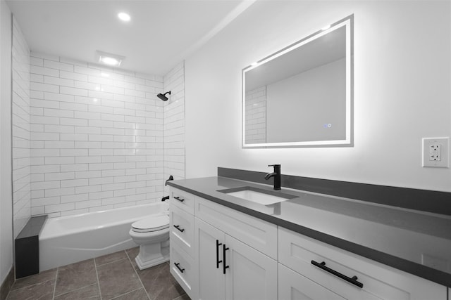 bathroom featuring toilet, shower / washtub combination, vanity, and tile patterned flooring