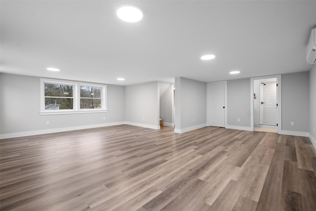 below grade area featuring recessed lighting, light wood-style floors, and baseboards