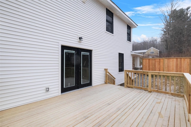 wooden deck featuring fence and french doors