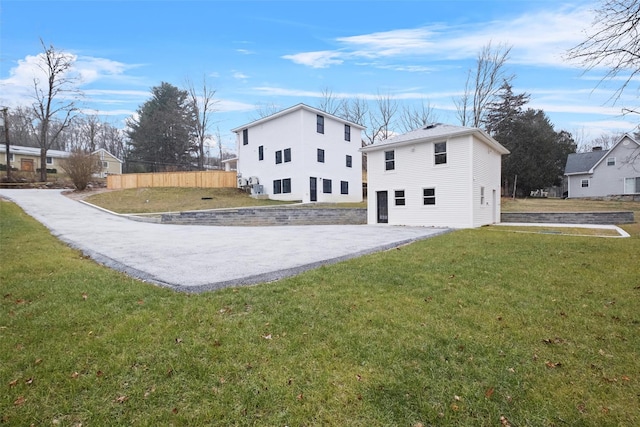 view of home's exterior featuring a yard and fence