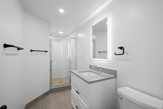 full bathroom featuring toilet, a stall shower, vanity, and tile patterned flooring