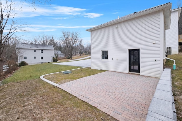 rear view of property with a patio area and a yard