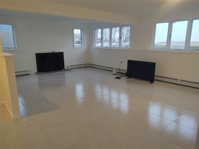 unfurnished living room with a baseboard heating unit, a fireplace with raised hearth, and tile patterned flooring