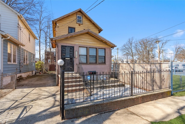 view of front of home featuring a fenced front yard and driveway