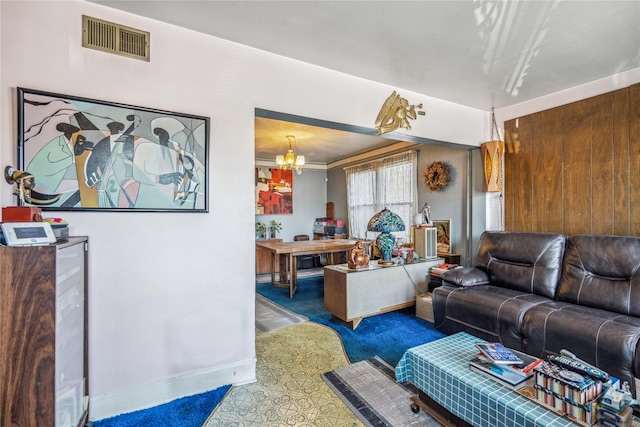 living area with a notable chandelier, visible vents, and carpet floors