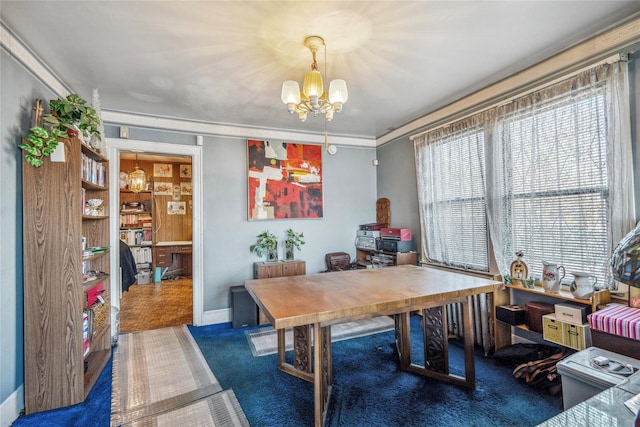 office space with an inviting chandelier, crown molding, and baseboards