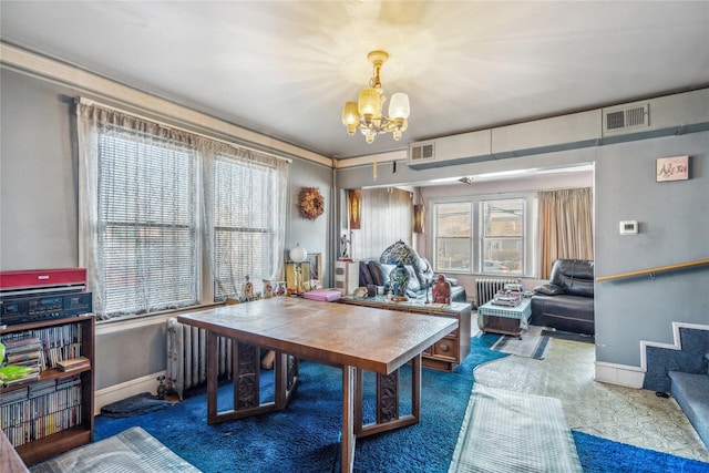 office space featuring visible vents, baseboards, and an inviting chandelier