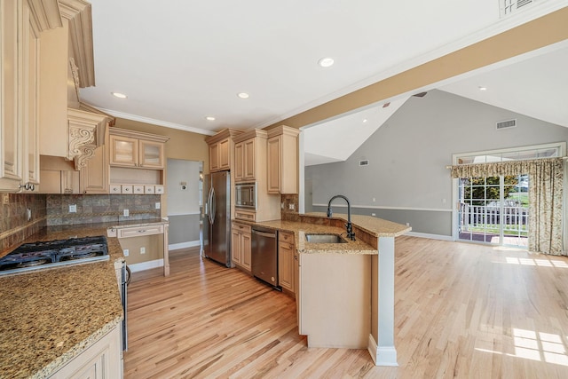 kitchen with light wood-style floors, a peninsula, visible vents, a sink, and stainless steel appliances