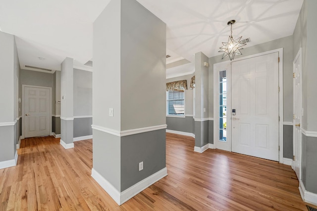 foyer entrance featuring light wood-style flooring and baseboards