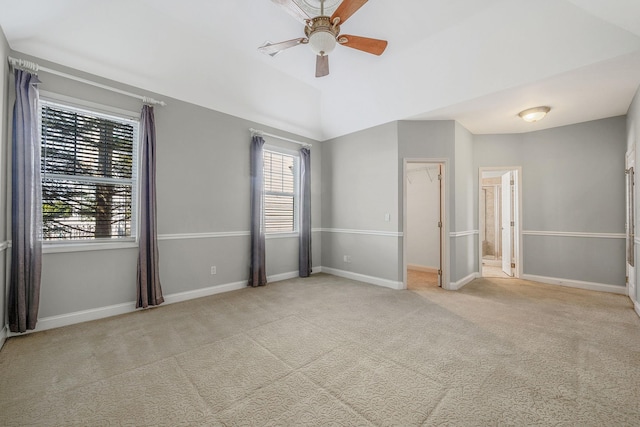 unfurnished bedroom with baseboards, carpet, and vaulted ceiling