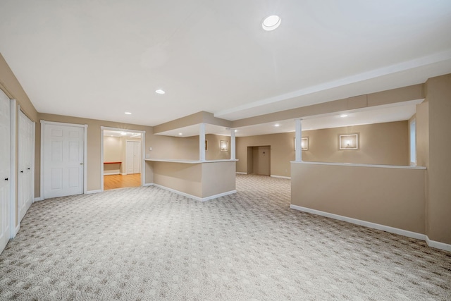 unfurnished living room featuring carpet flooring, baseboards, and recessed lighting