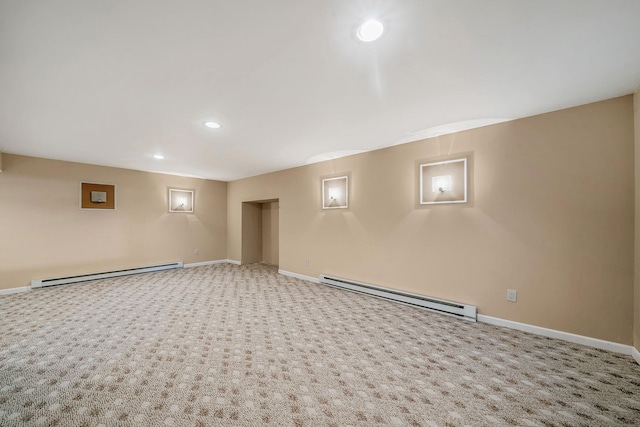 finished basement featuring a baseboard radiator, baseboards, and carpet floors