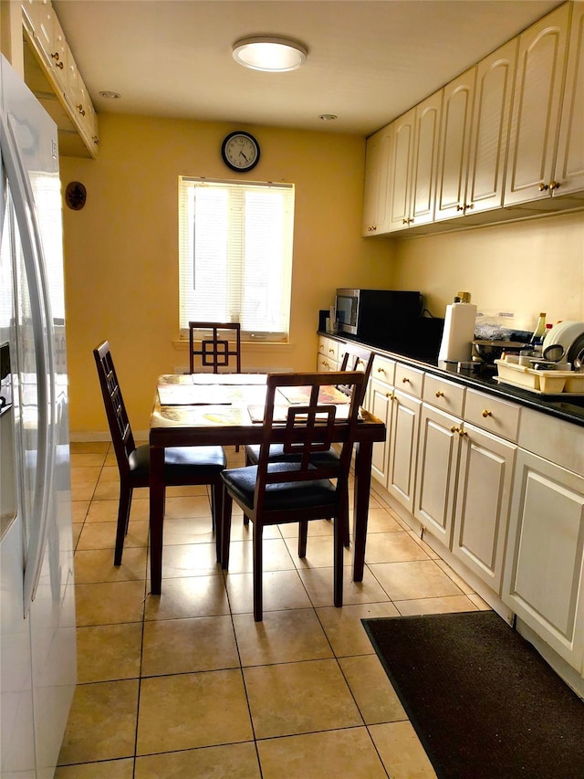 dining space featuring light tile patterned flooring