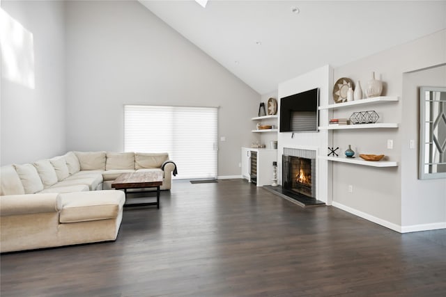 living room with baseboards, a lit fireplace, dark wood finished floors, and high vaulted ceiling