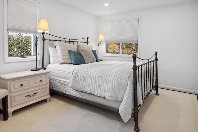 bedroom with recessed lighting, light colored carpet, and baseboards