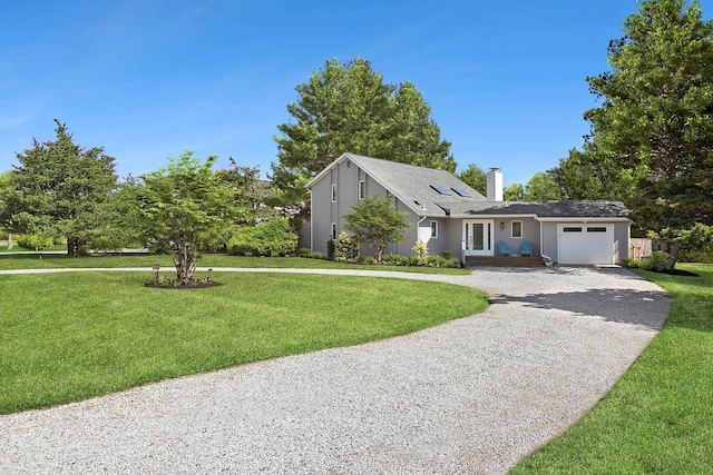 view of front of home with a front yard, a chimney, stucco siding, an attached garage, and gravel driveway
