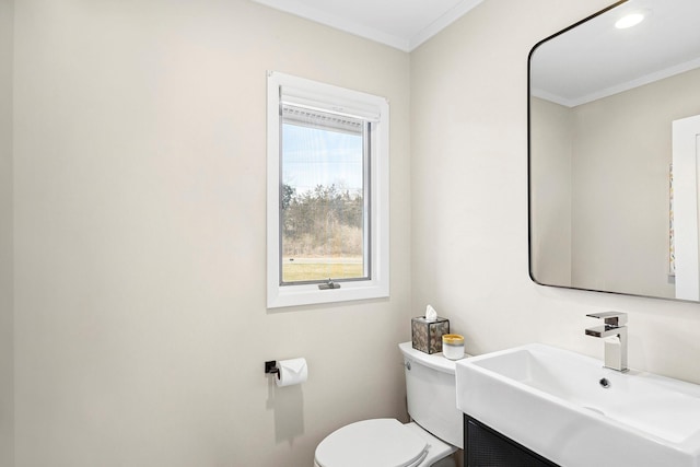 half bath featuring toilet, vanity, crown molding, and recessed lighting