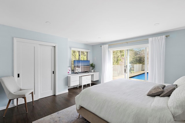 bedroom with access to outside, a closet, baseboards, and dark wood-style flooring