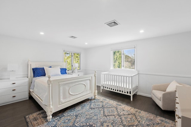 bedroom with recessed lighting, visible vents, multiple windows, and dark wood finished floors