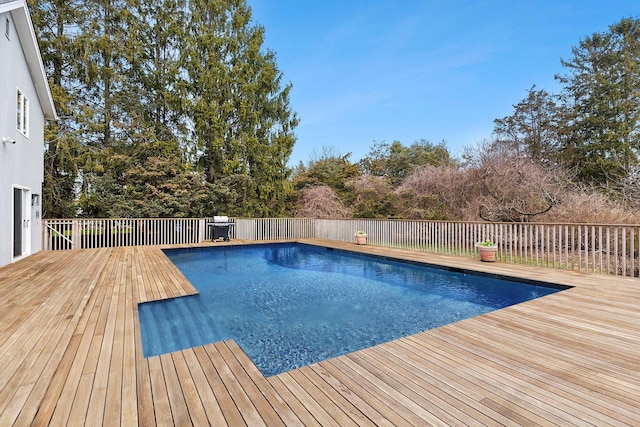view of swimming pool featuring a fenced in pool and a wooden deck