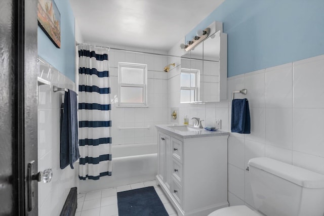 full bath with tile patterned flooring, toilet, vanity, tile walls, and shower / bathtub combination with curtain