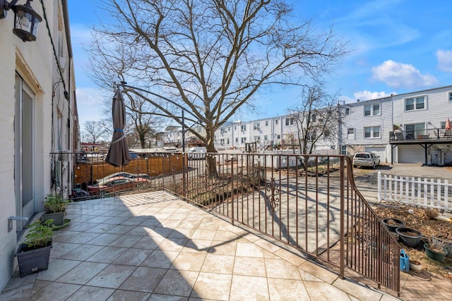 view of patio featuring a residential view and fence