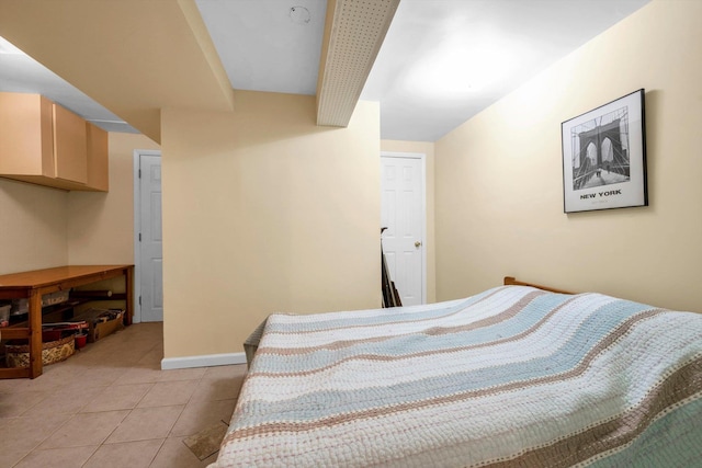 bedroom with baseboards and light tile patterned flooring