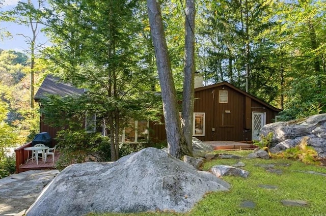 back of property featuring a patio and a chimney